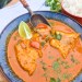 Brazilian Fish Stew with flakey cod poached in a flavorful spicy coconut tomato stew with red and yellow peppers and fresh lime.