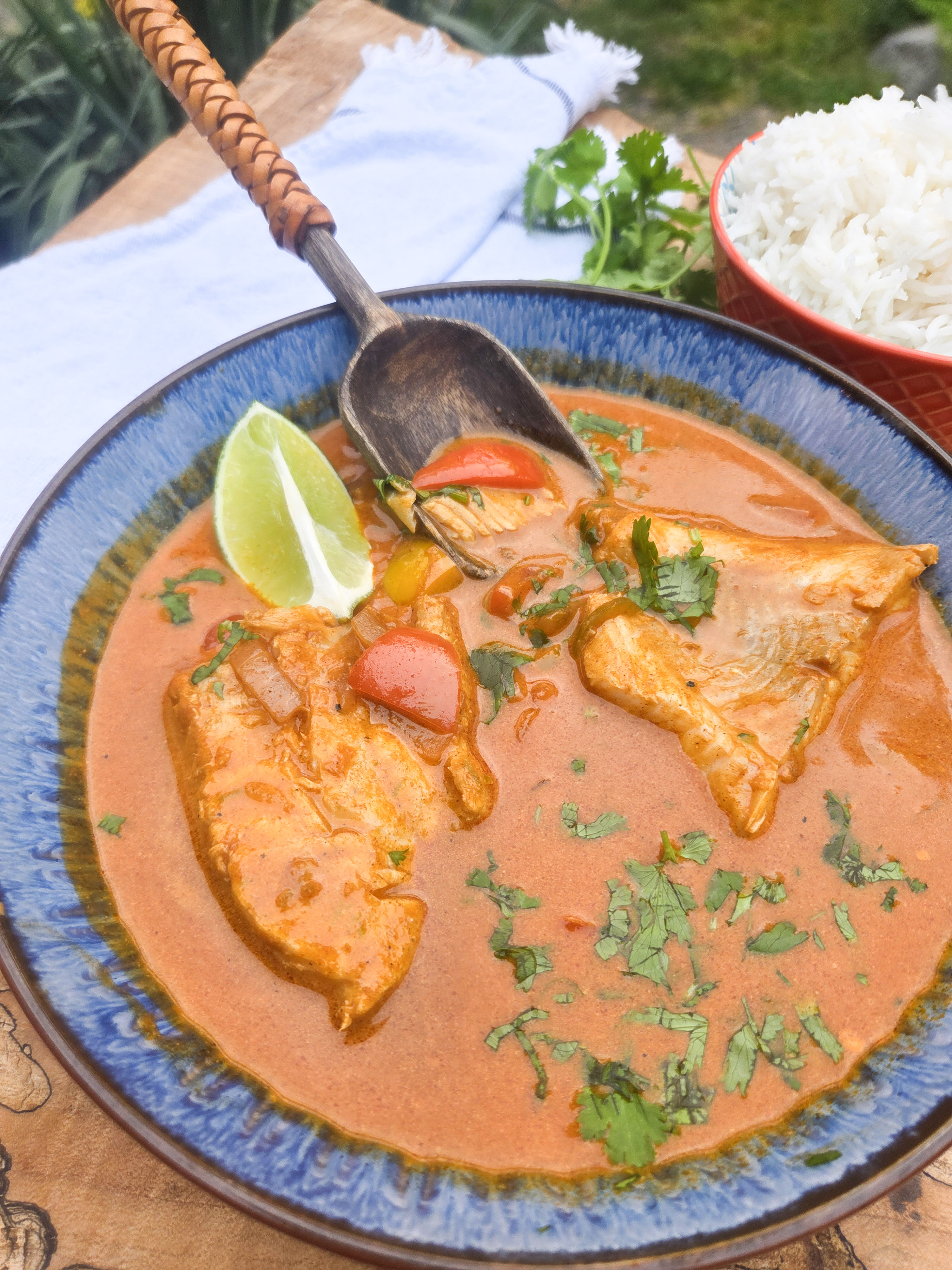 Brazilian Fish Stew with flakey cod poached in a flavorful spicy coconut tomato stew with red and yellow peppers and fresh lime.