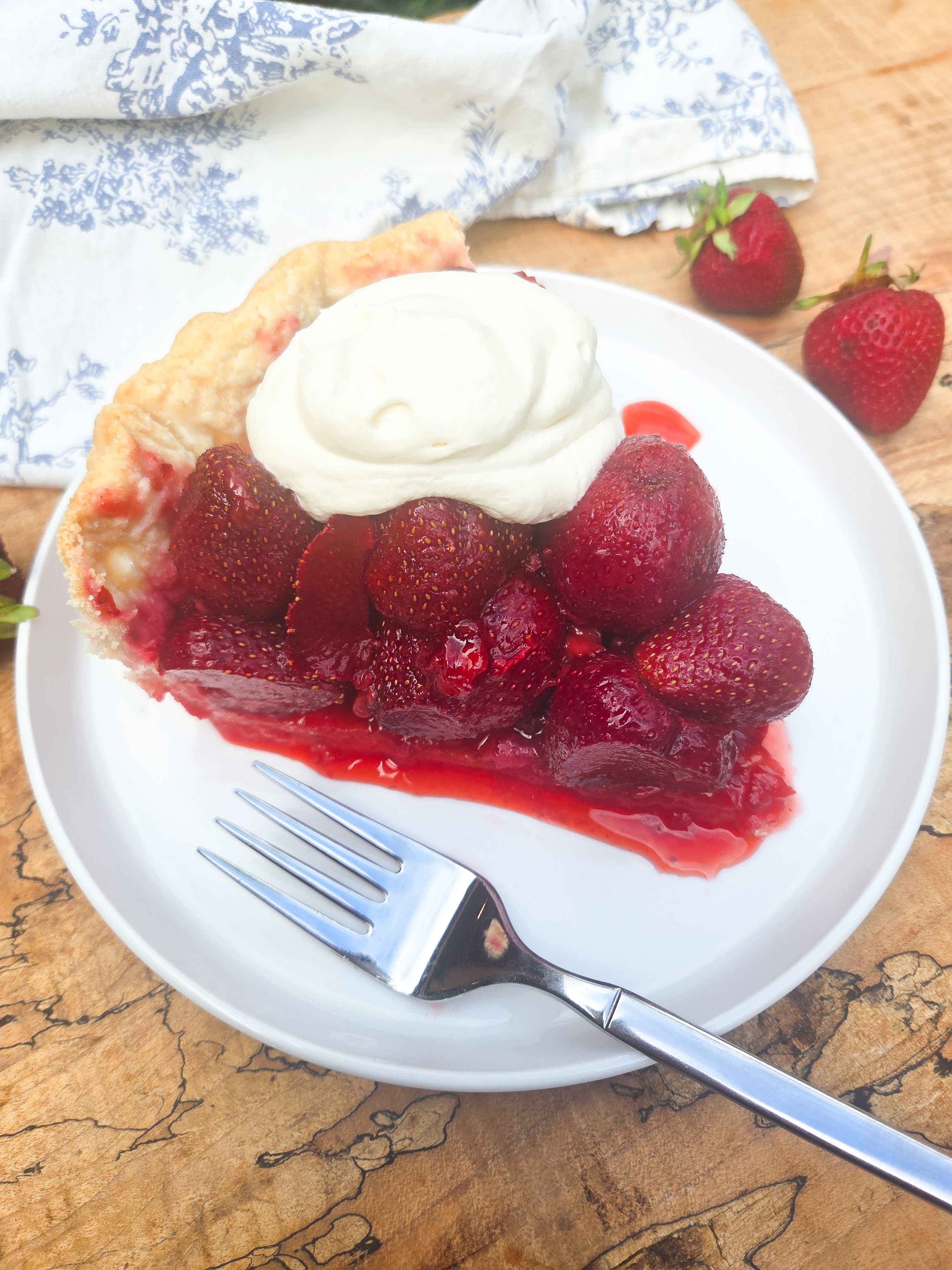 Strawberry Pie is a classic with fresh glazed strawberries in a flaky all butter crust with whipped cream.