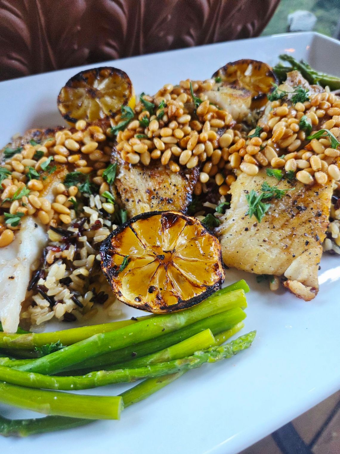 Pan Seared Halibut with Pine Nuts is buttery, tender, and melt-in-your-mouth delicious, finished with toasted pine nuts and served with grilled lemon