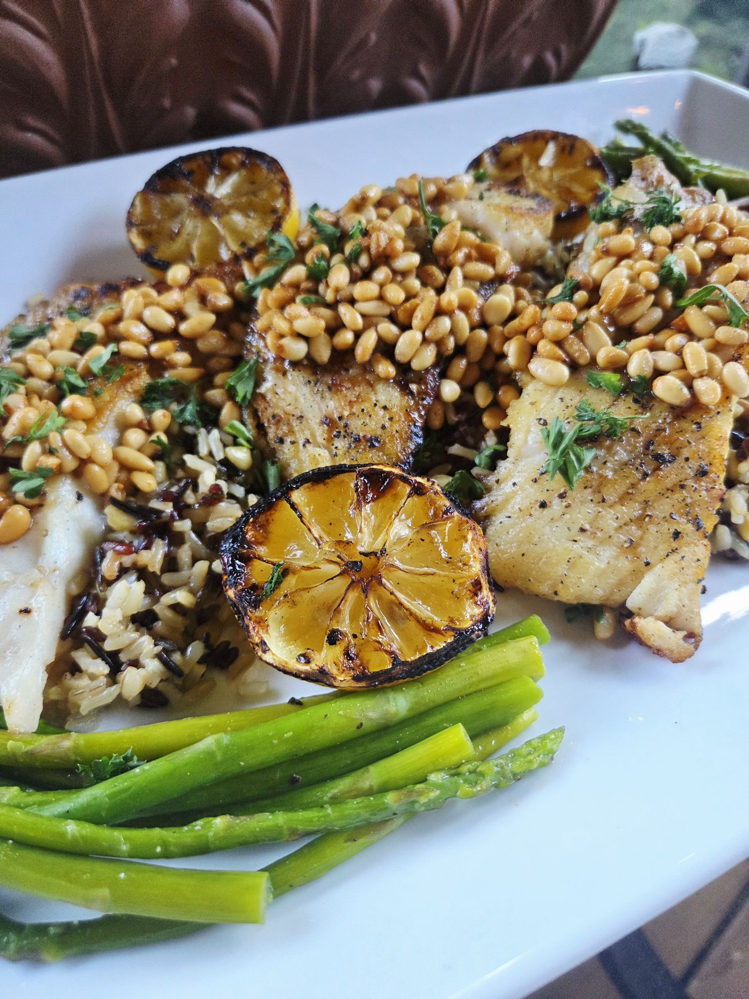 Pan Seared Halibut with Pine Nuts is buttery, tender, and melt-in-your-mouth delicious, finished with toasted pine nuts and served with grilled lemon