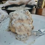 Fluffy layers of biscuit with creamy sausage gravy spooned over top