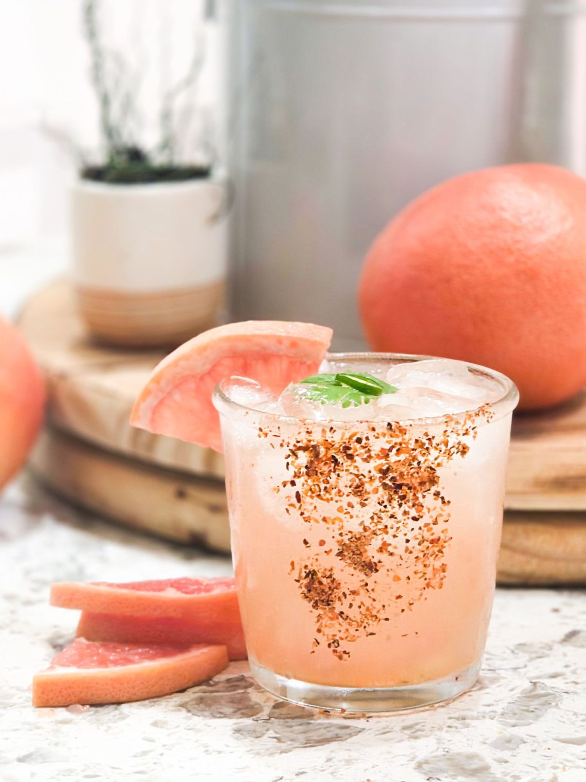 Glass of Salty Owl Paloma with Tajin rim and grapefruit slices