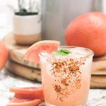 Glass of Salty Owl Paloma with Tajin rim and grapefruit slices