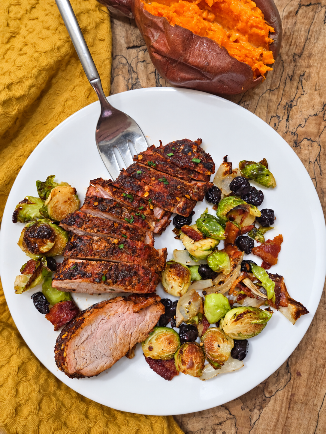 Sliced honey Cajun smoked pork loin with roasted Brussels sprouts and onions