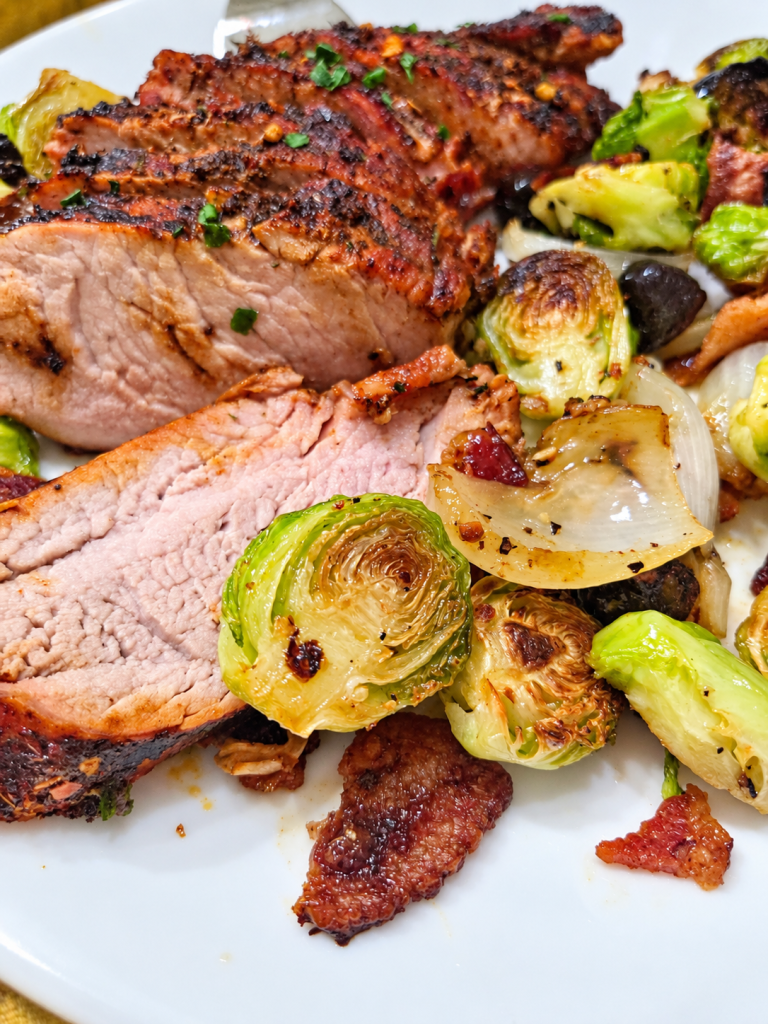 Sliced honey Cajun smoked pork loin with roasted Brussels sprouts and onions