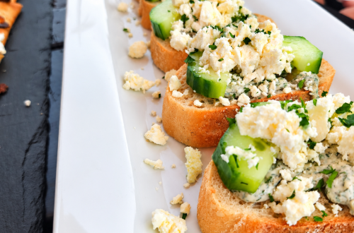 Cucumber bruschetta at The Lighthouse Bar & Restaurant with toasted rustic baguette, creamy dill spread, fresh cucumber slices, and crumbled feta cheese.
